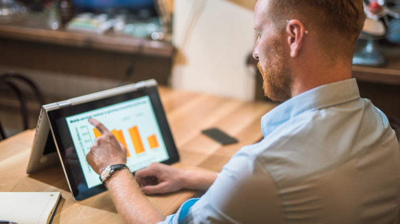 Person using a touchscreen laptop
