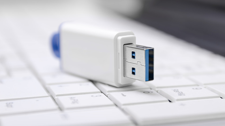 usb flash drive placed on a white keyboard