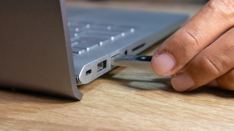 USB flash drive being connected to a laptop