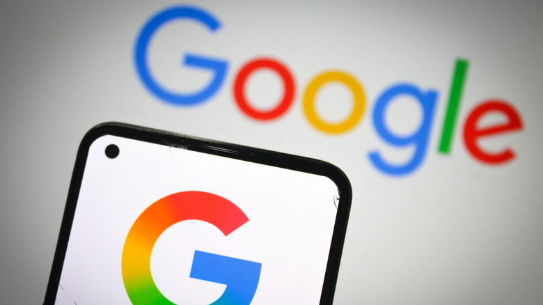 A mobile screen with the Google logo on it, and Google text in the background