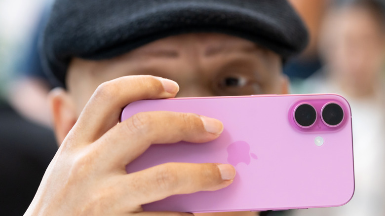 A shopper at the Apple Store in Tokyo, Japan tries an iPhone 16.