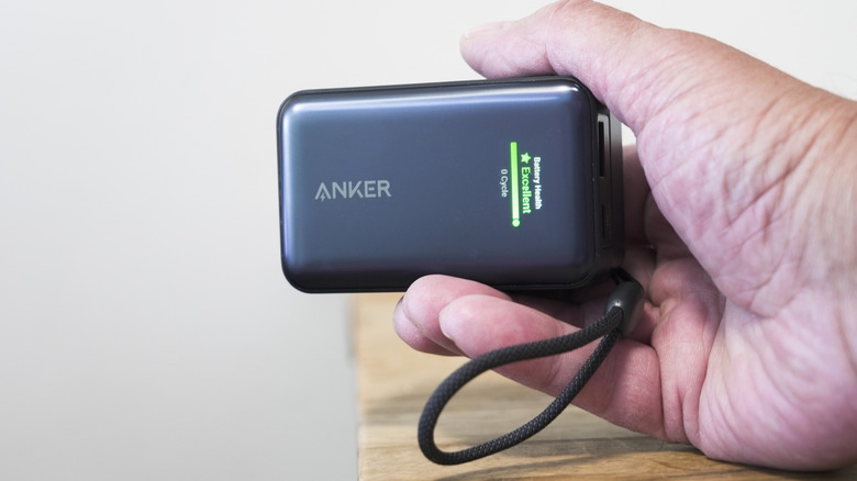An Anker Nano battery pack clasped within a hand.