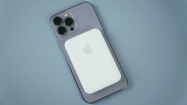 A MagSafe battery atop an iPhone.