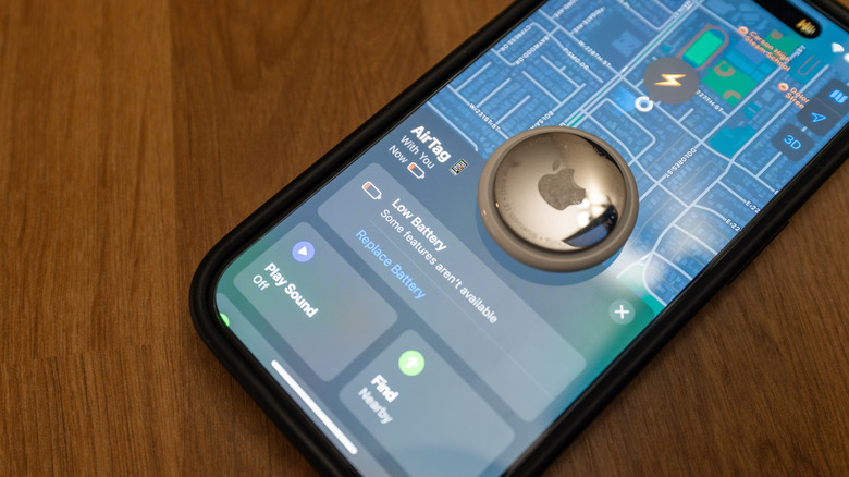 An iPhone showing AirTag low battery alert with it on the top