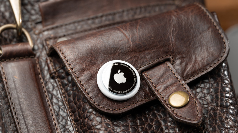 An AirTag placed on a leather hand bag