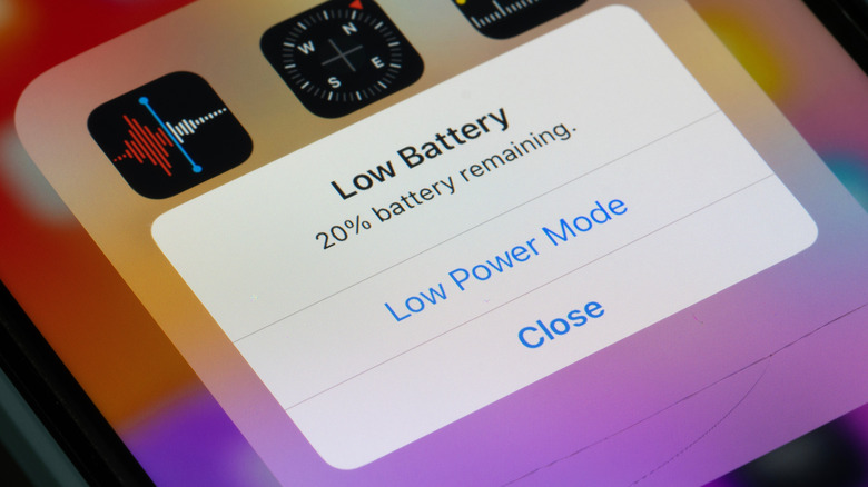 A closeup of an iPhone screen as it displays a Low Battery warning, the user has the option to select Low Power Mode or Close from the window