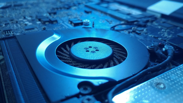 A laptop cooling fan under blue lighting.
