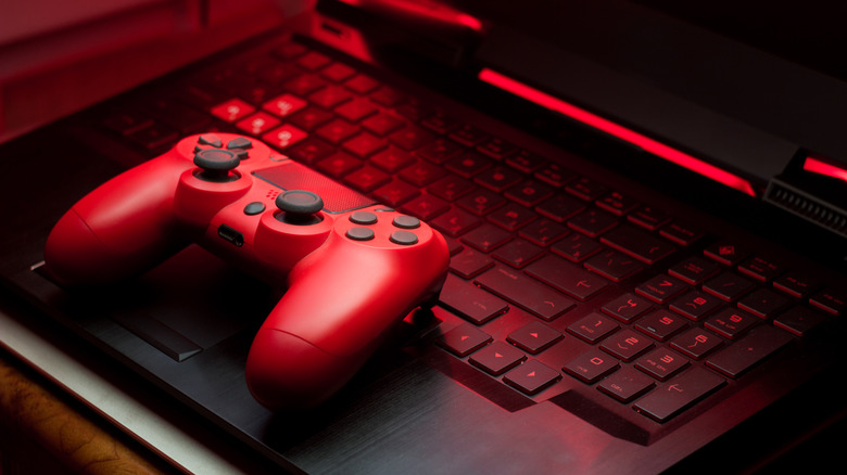 Streamer gaming at an RGB-lit PC with headset and microphone.