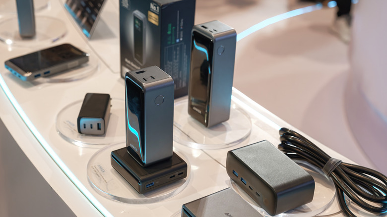 An Anker display at a store or trade show showing different chargers and battery banks with screens