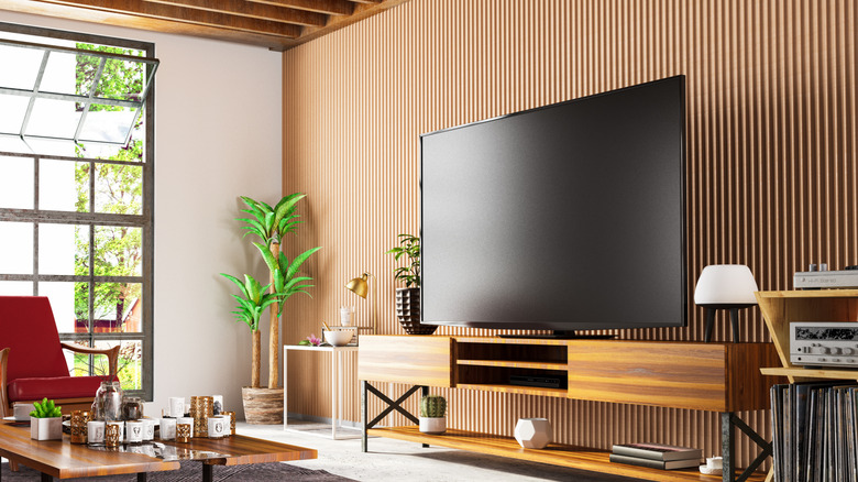 An OLED TV in a brightly-lit room