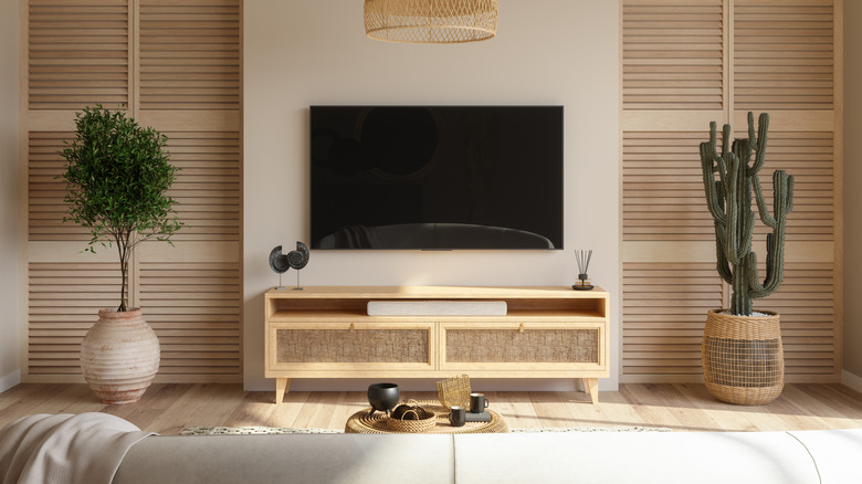 A smart tv mounted on the wall in a living room