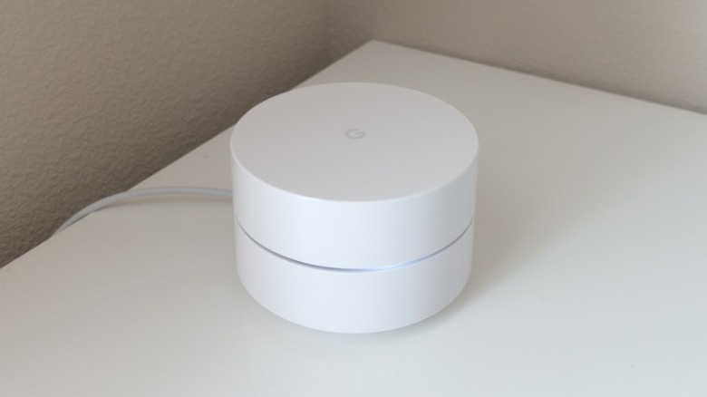 Three of the Google AC1200 Mesh Wi-Fi routers next to each other
