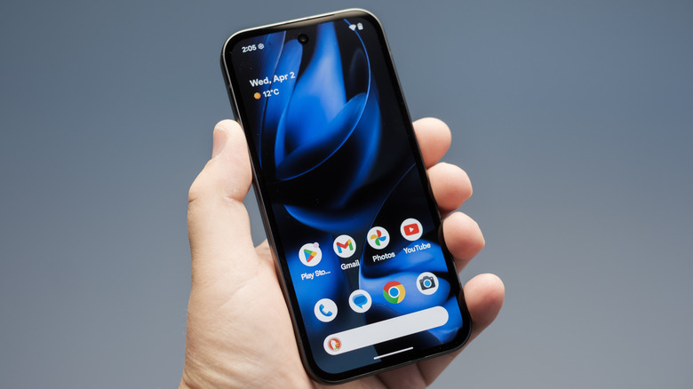 A hand holding the Google Pixel 9 phone