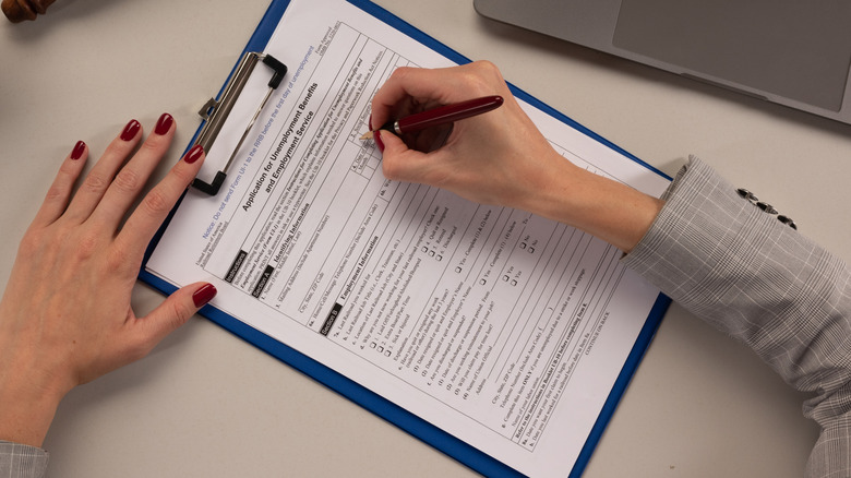 a woman applies for unemployment benefits