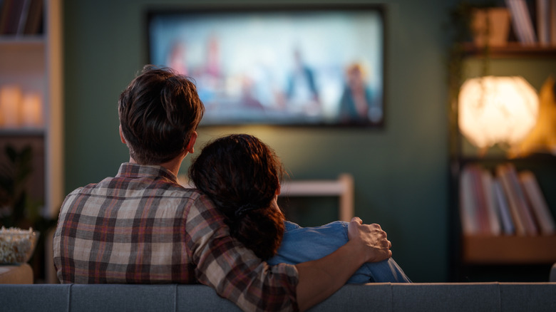 A couple watching TV at home