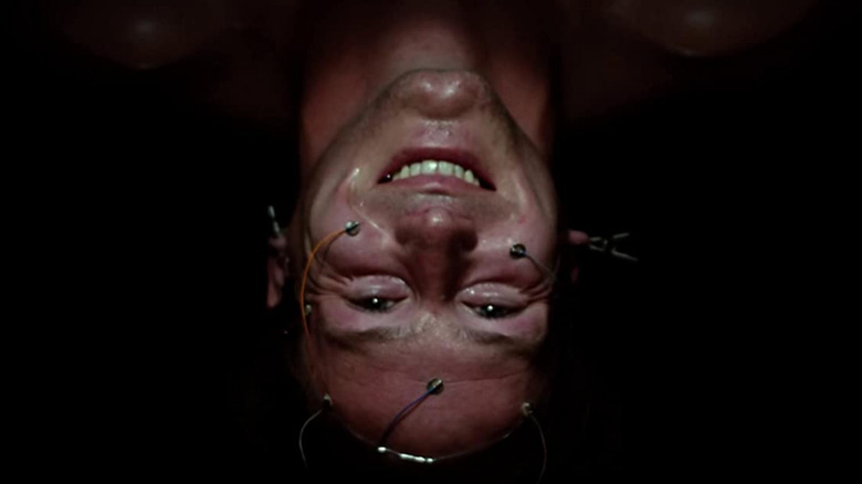 Edward (William Hurt) hanging upside down and smiling in "Altered States."