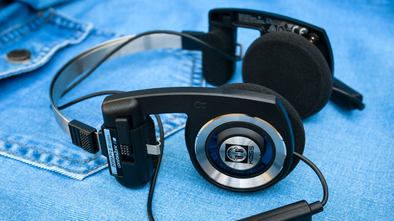 Koss Porta Pro headphones on a denim garment laid flat on a surface.