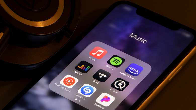 A phone screend displaying the app icons of the most popular music streaming services.