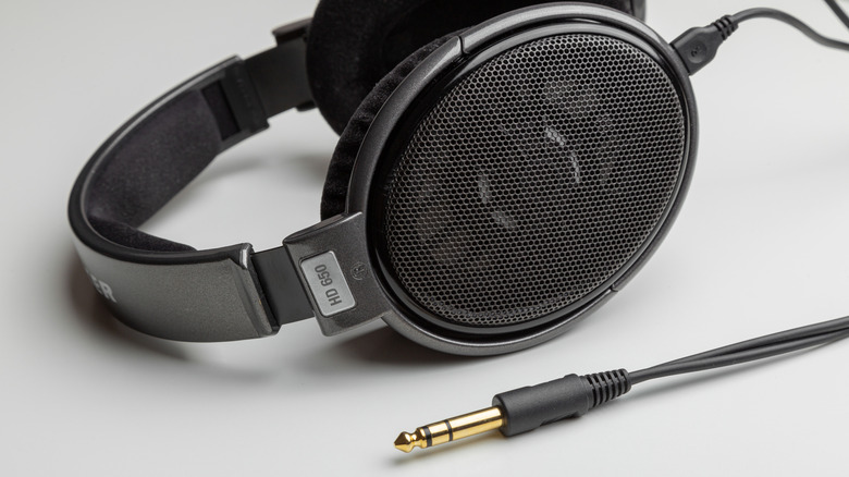 Sennheisser HD650 open-back headphones on a flat surface with the audio connector visible.