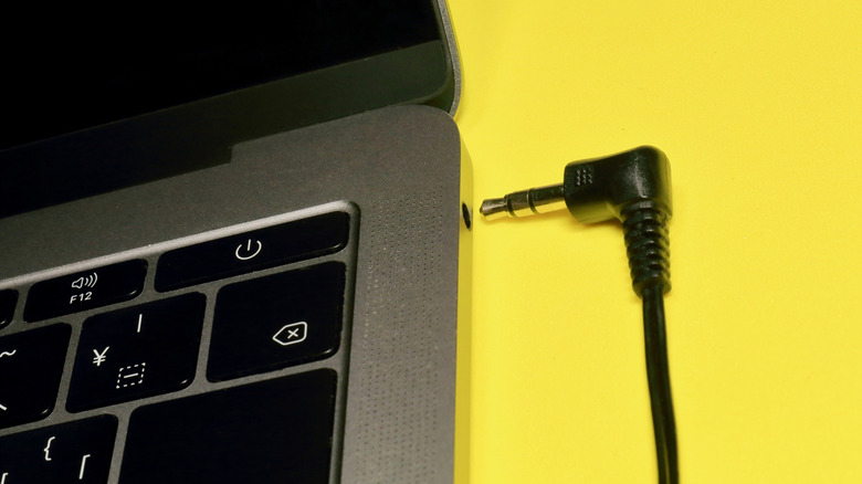 A headphone jacks with a headphone connector right outside it, suggesting that it's about to be plugged in.