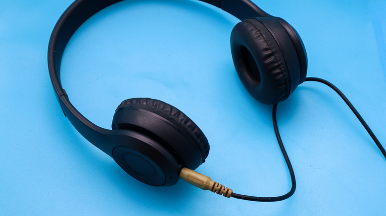 Black wired over-ear headphones with a 3.5mm audio cable.