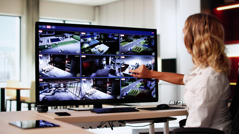 A person monitoring home security camera footage