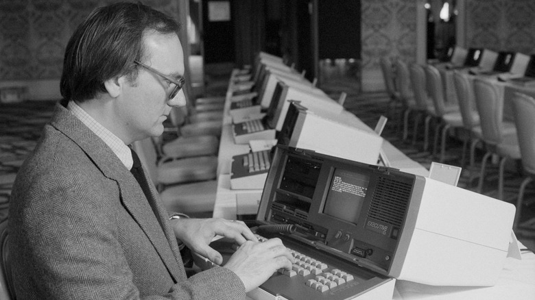 person using an Osborne portable computer