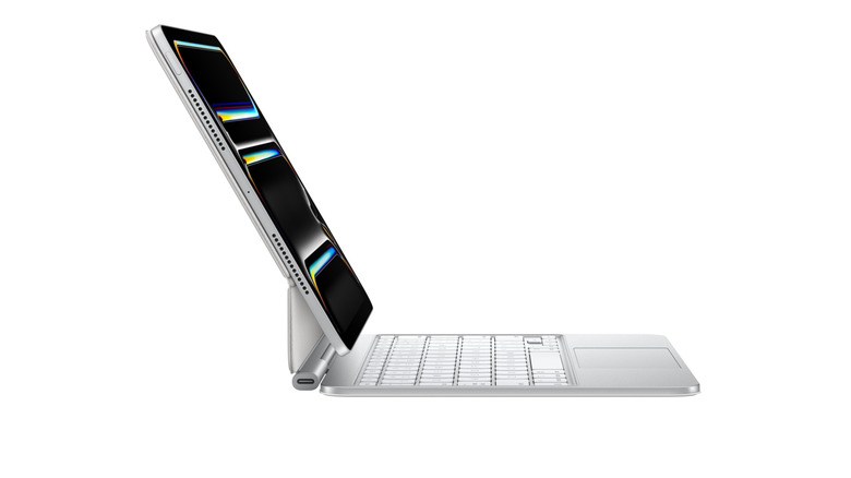 An iPad with a white Magic Keyboard seen from the side