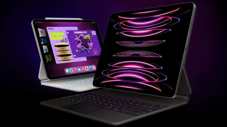 Two iPad Pros, one in a black keyboard case and the other in a white one, on a black and purple background.