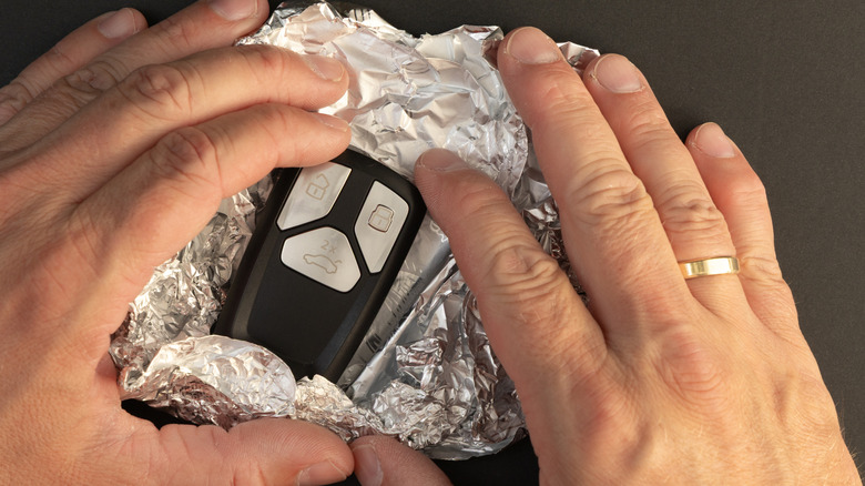 car key fob surrounded by aluminum foil