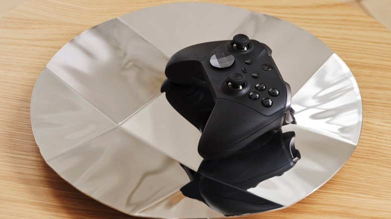An Xbox controller laying on a gaming D-pad controller platter.