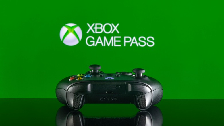 xbox controller in front of green background with xbox game pass text in white