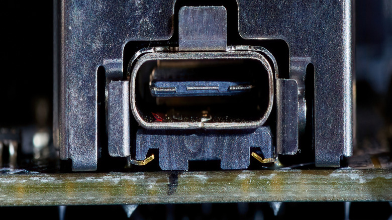 A close-up photograph of a teal USB connector.