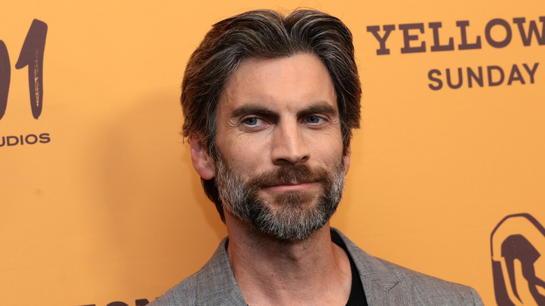 Wes Bentley on a yellow backdrop for a Yellowstone event.