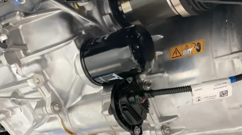 Tesla Model Y gearbox oil filter visible on underside of the vehicle.