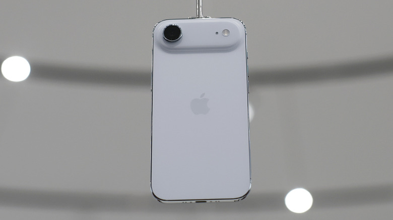 A white iPhone 17 Air dangling from a metal rod