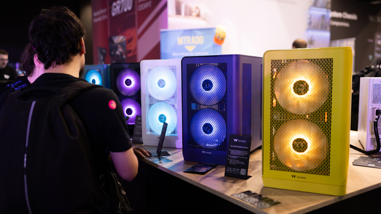 An array of desktop PCs at a gaming convention.
