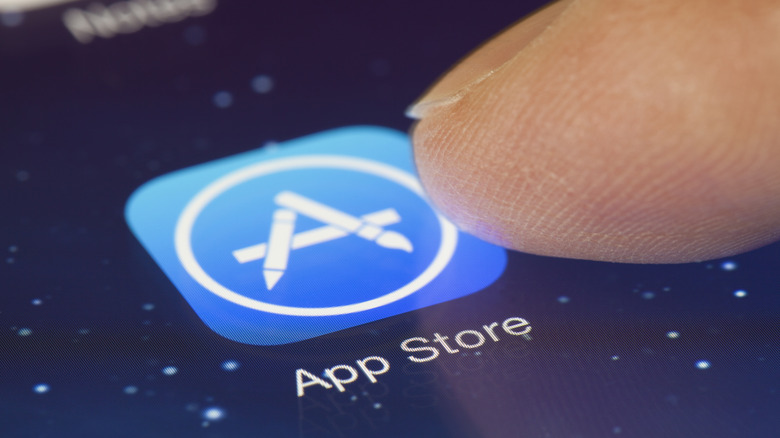 finger hovering over app store icon for apple's app store on iPhone