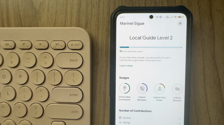 A phone showing the Google Maps Local Guides details page