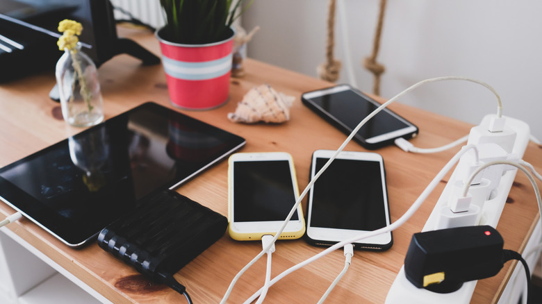 Phones connected to a power strip.