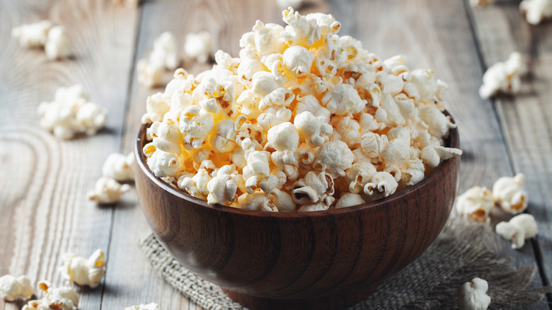 A bowl of popcorn on a wooden table.