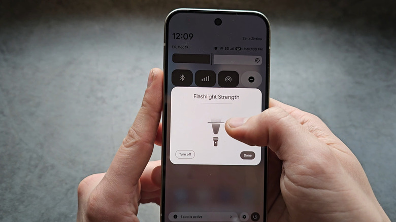 person adjusting the flashlight brightness on Google Pixel