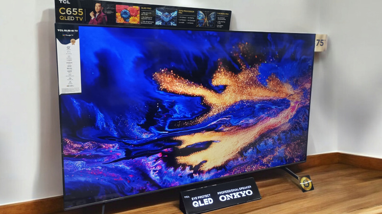 A 75-inch TCL TV displaying a screensaver