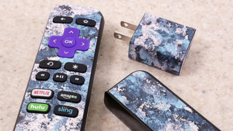 The Roku Express and included remote control and power adapter, each wrapped in a custom skin.