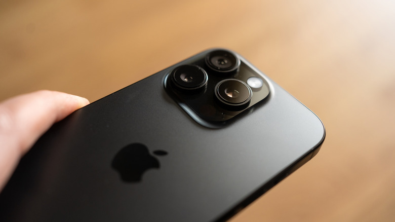 A person holding a black iPhone