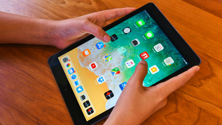 Hands holding an iPad
