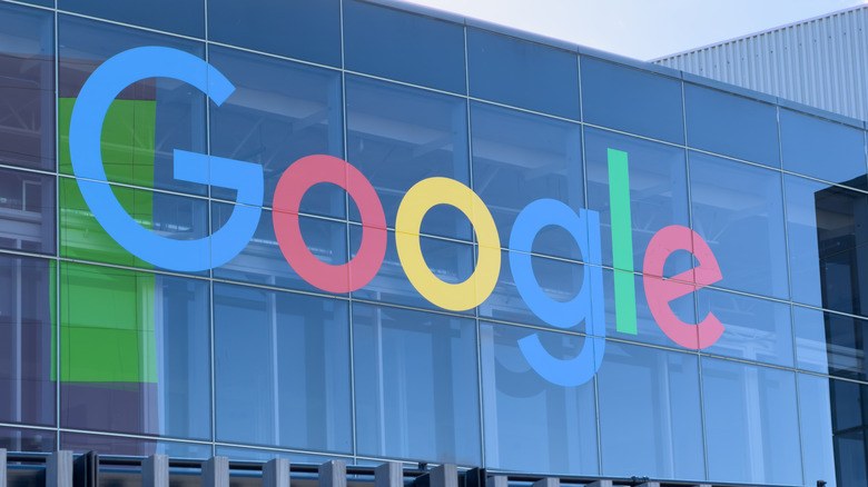 A picture of the Google logo on a transparent glass building