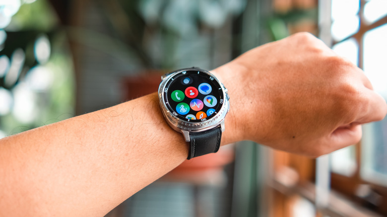A closeup of an individual's arm that has a Samsung Galaxy Watch 8 with a black band wrapped around the wrist
