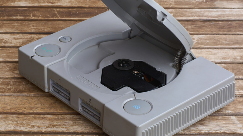 A PlayStation 1 on a wood floor