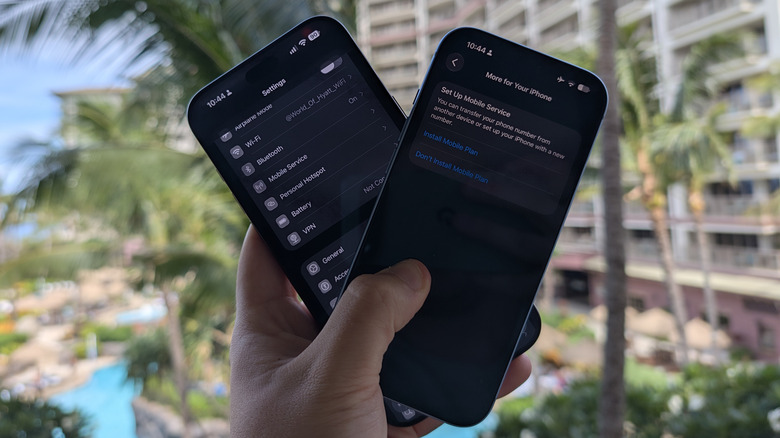 Holding up two iPhones with Settings and SIM settings open